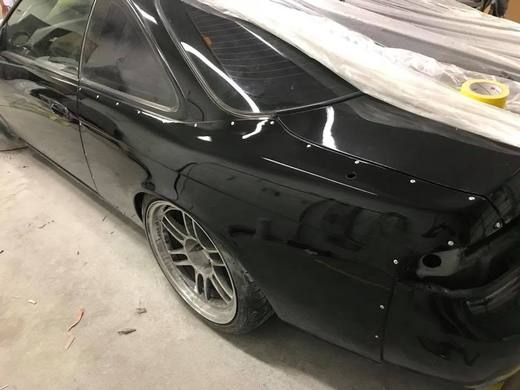 A black coupe with the front corner pushed in