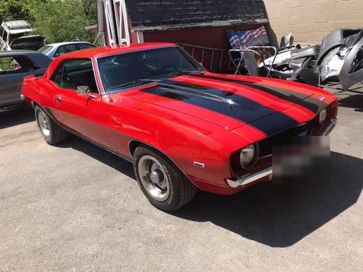 A Camaro in red with black stripes