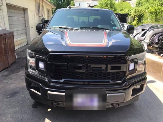 A blacked-out F-150 head-on